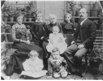 Francis Burley Pluck Family 
This is a really old one. I am not certain who is who. According to Cynthia Cave who has the same photo with some notes on it and dated 1902.
Missing is Jesse who was born in 1901 which is the date written on the back of the picture I have
Left to Right Front to Back.
Arthur, Douglas
Georgina Amy [Durell], Ethel, Francis Burley,
Frank, possibly Jane Anne [Dyer] or someone from the Durell side, Maude.  
